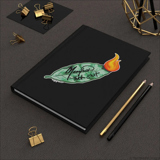 Black hardcover journal with matte laminated cover featuring a bay leaf design and manifest that slut phrase with orange flame