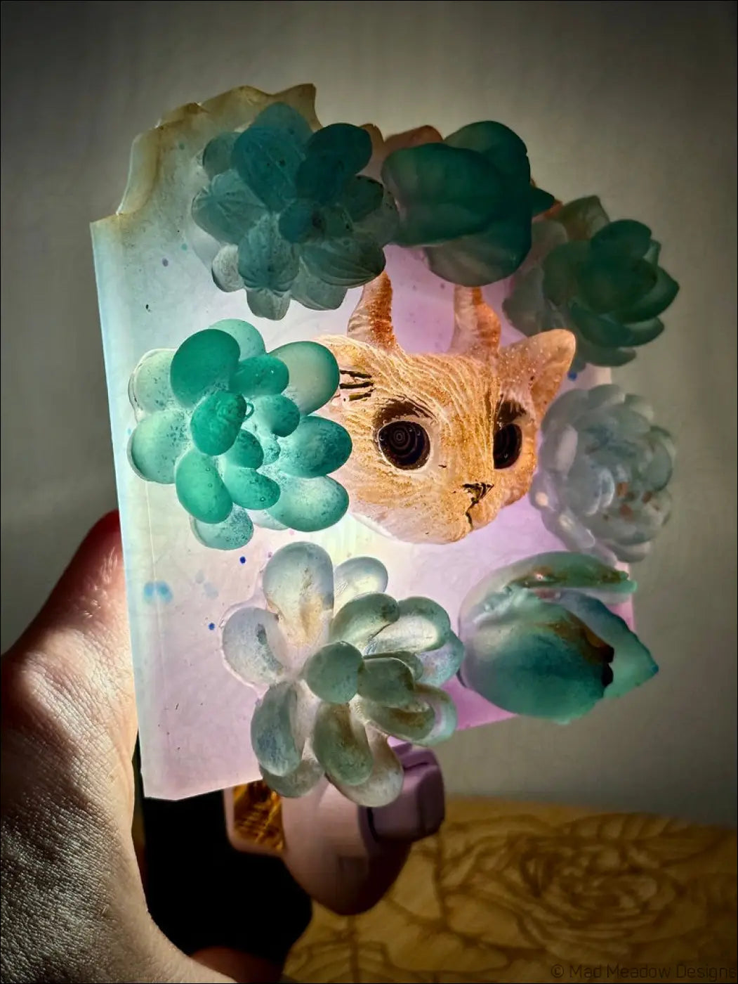 Translucent resin horned kitty cat pendant with orange face and green succulent flowers for garden wall night light