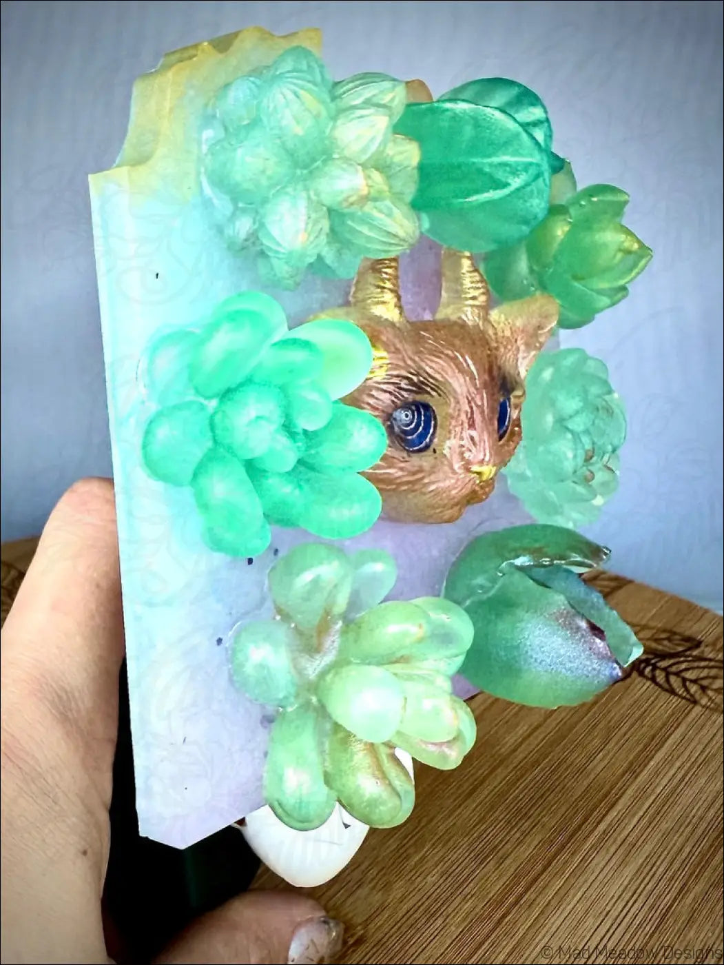 Whimsical resin horned kitty cat wall night light with golden cat and green succulents on plug-in base