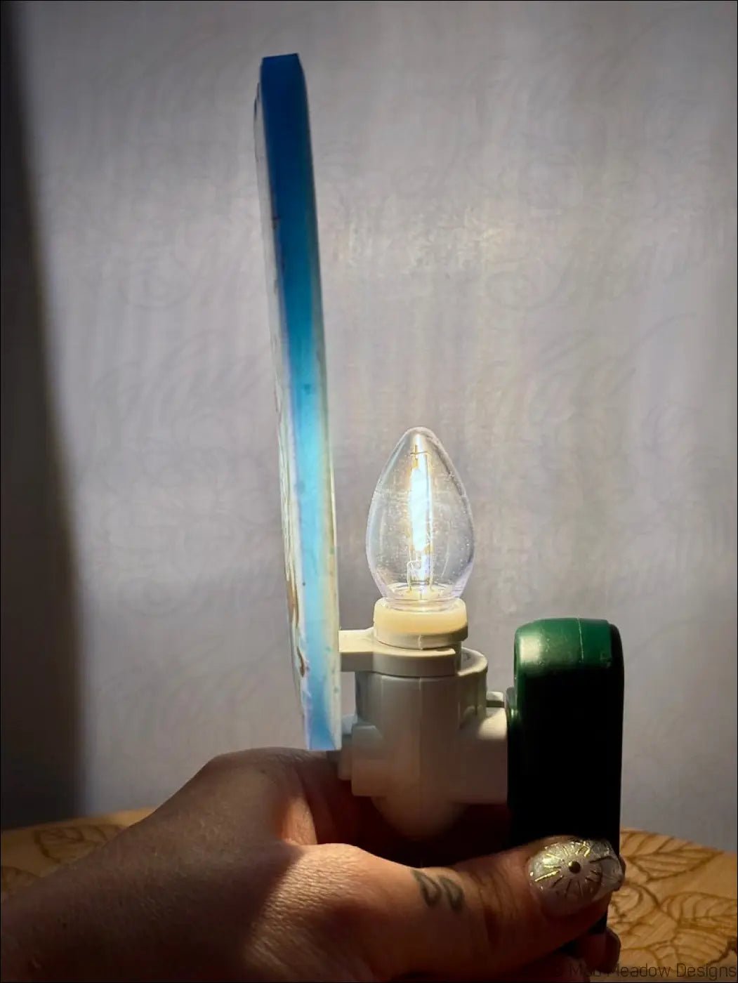 A mesmerizing magician tarot iridescent blue and white acrylic resin wall night light with candle bulb and plug-in base