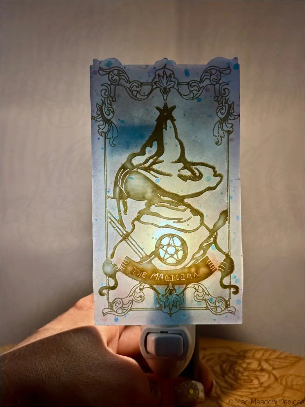Iridescent magician tarot resin wall night light with translucent blue and gold design and glowing pentagram base