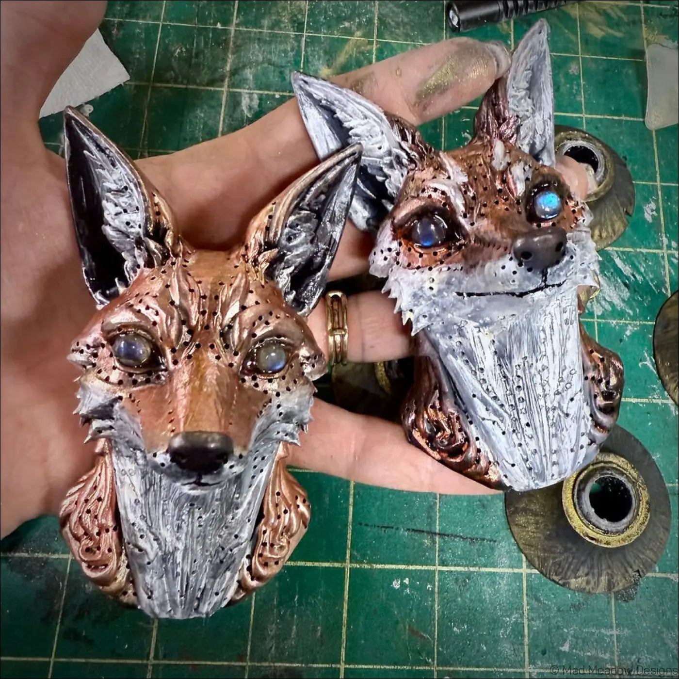 Two 3d printed red fox wall sculptures with natural labradorite eyes in copper and silver tones with metallic sheen