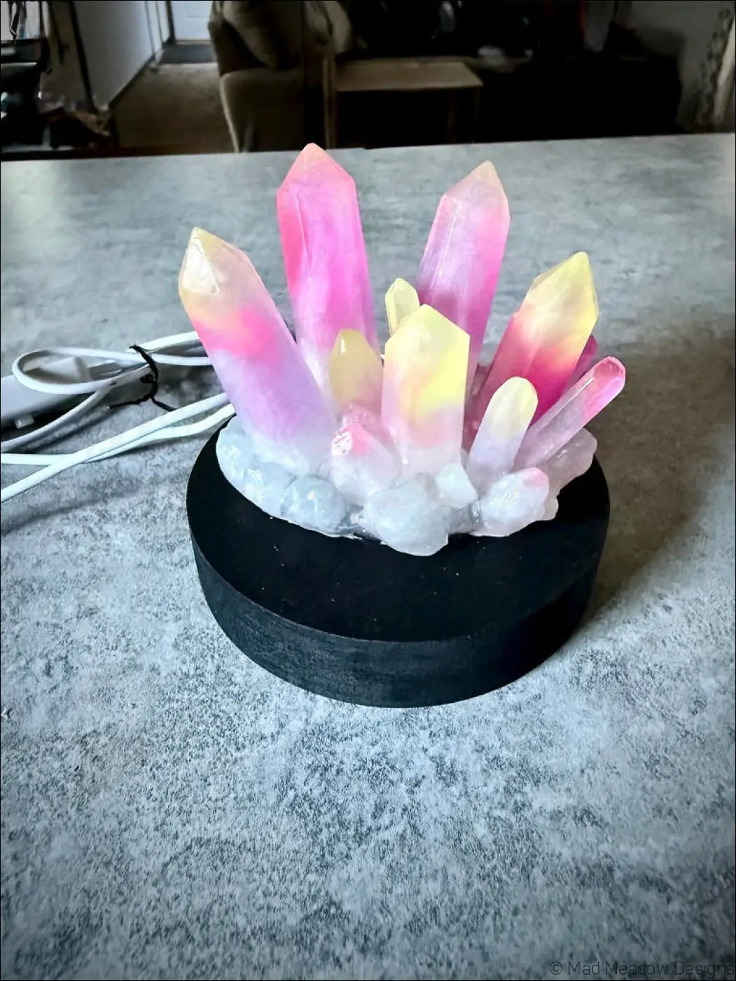 Large resin crystal cluster glow in the dark lamp with vibrant pink and yellow resin crystal on black wooden base