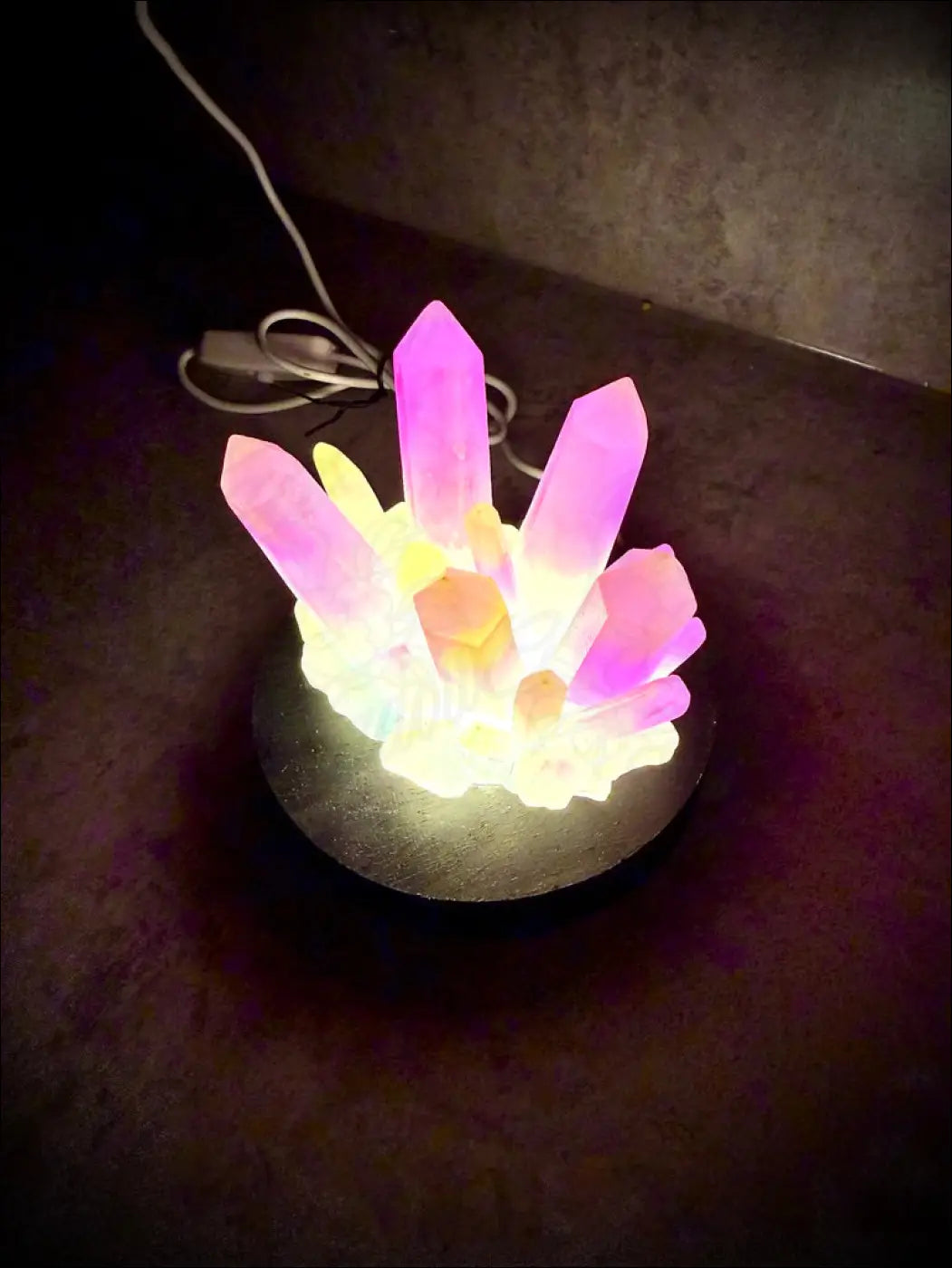 Large resin crystal cluster glow in the dark lamp with pink and yellow resin crystal facets on dark wooden base