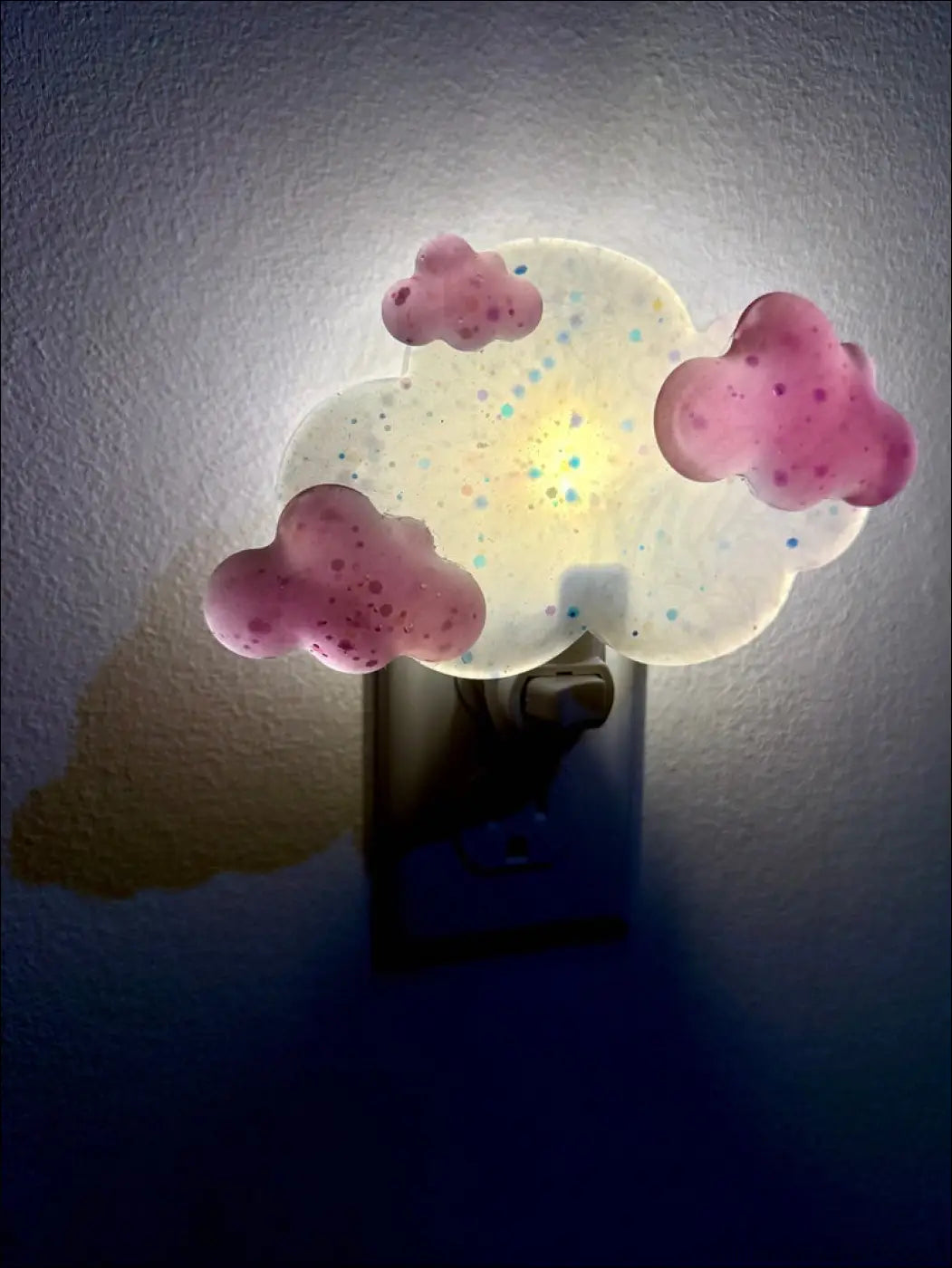 Magenta clouds wall night light with pink speckled clouds and colorful glitter center by mad meadow designs plug in base