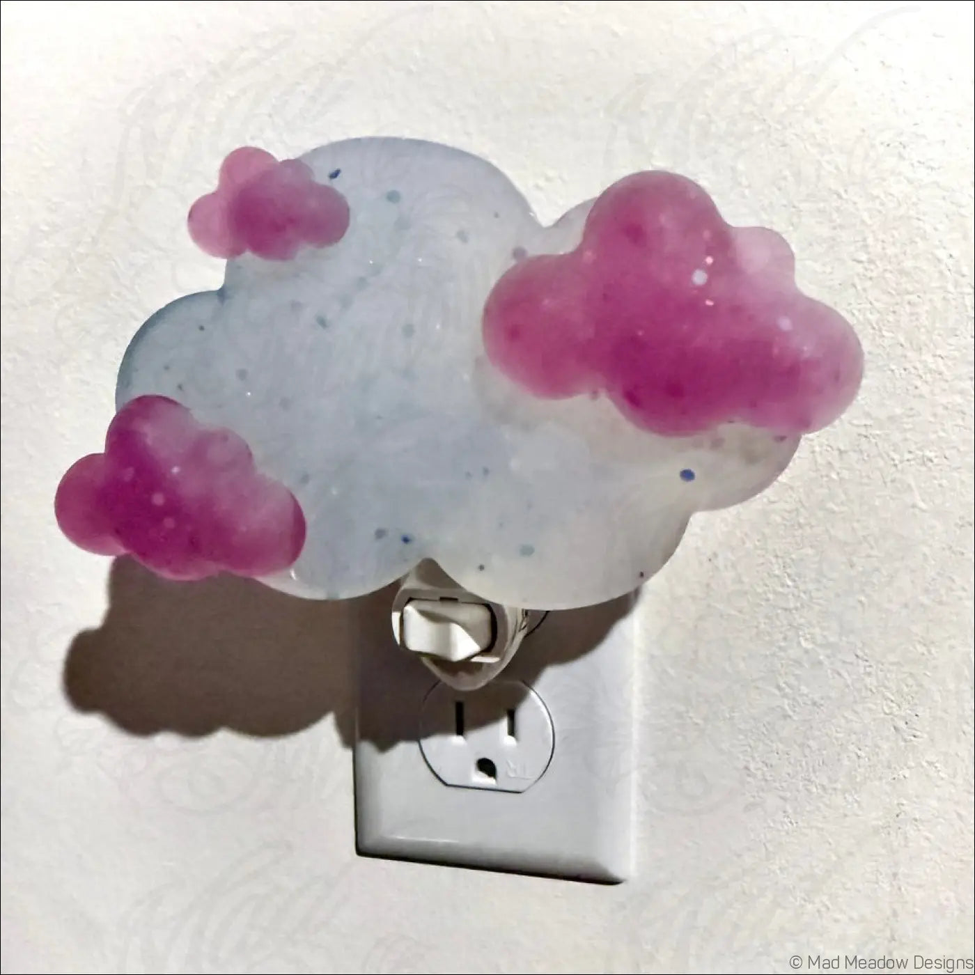 Magenta clouds wall night light with translucent glittery cloud and pink accents on silver plug-in base by mad meadow designs
