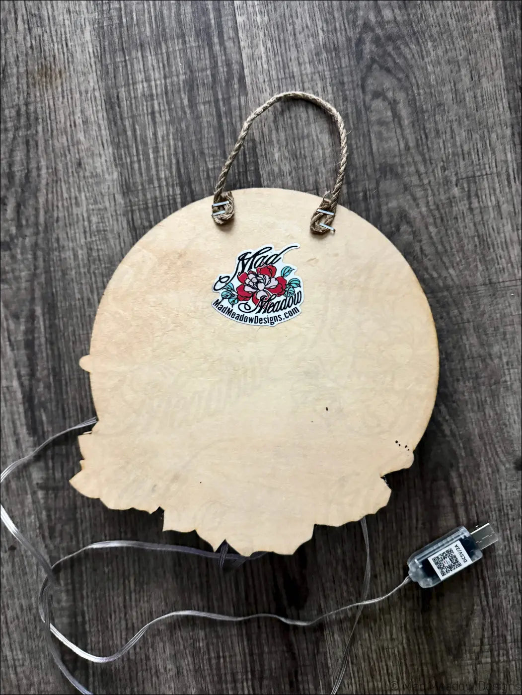 Lighted wooden circular wall hanging with rustic leaf-shaped edge and braided rope highlights mushroom forest ablaze vibe