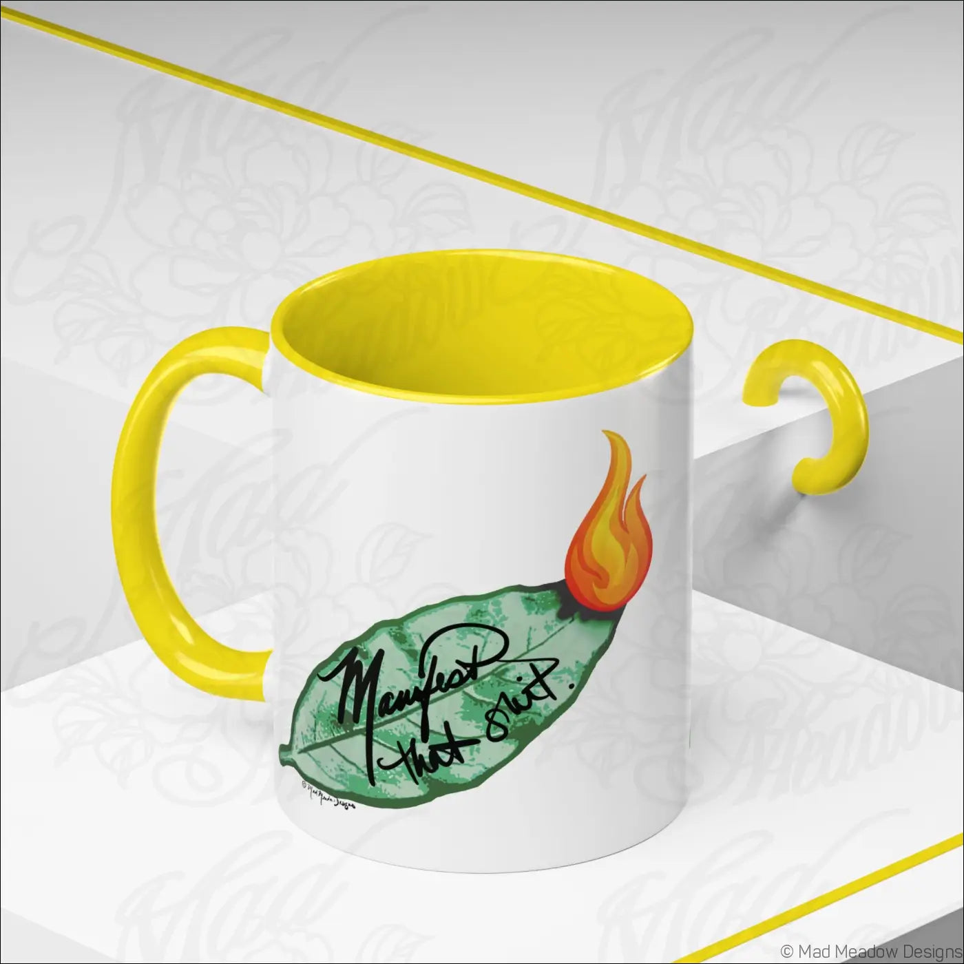 White ceramic coffee mug with glossy finish colored yellow interior handle bay leaf design and manifest that slut text