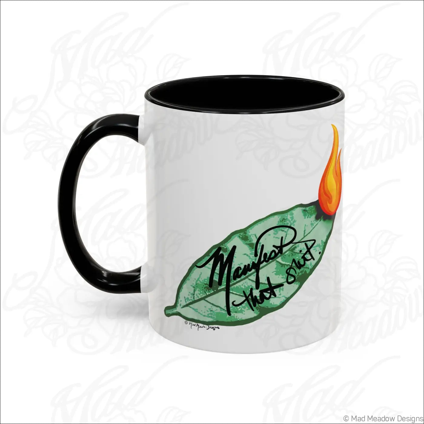 White ceramic mug with glossy finish black handle and interior featuring green bay leaf and orange flame design with may not that shut text