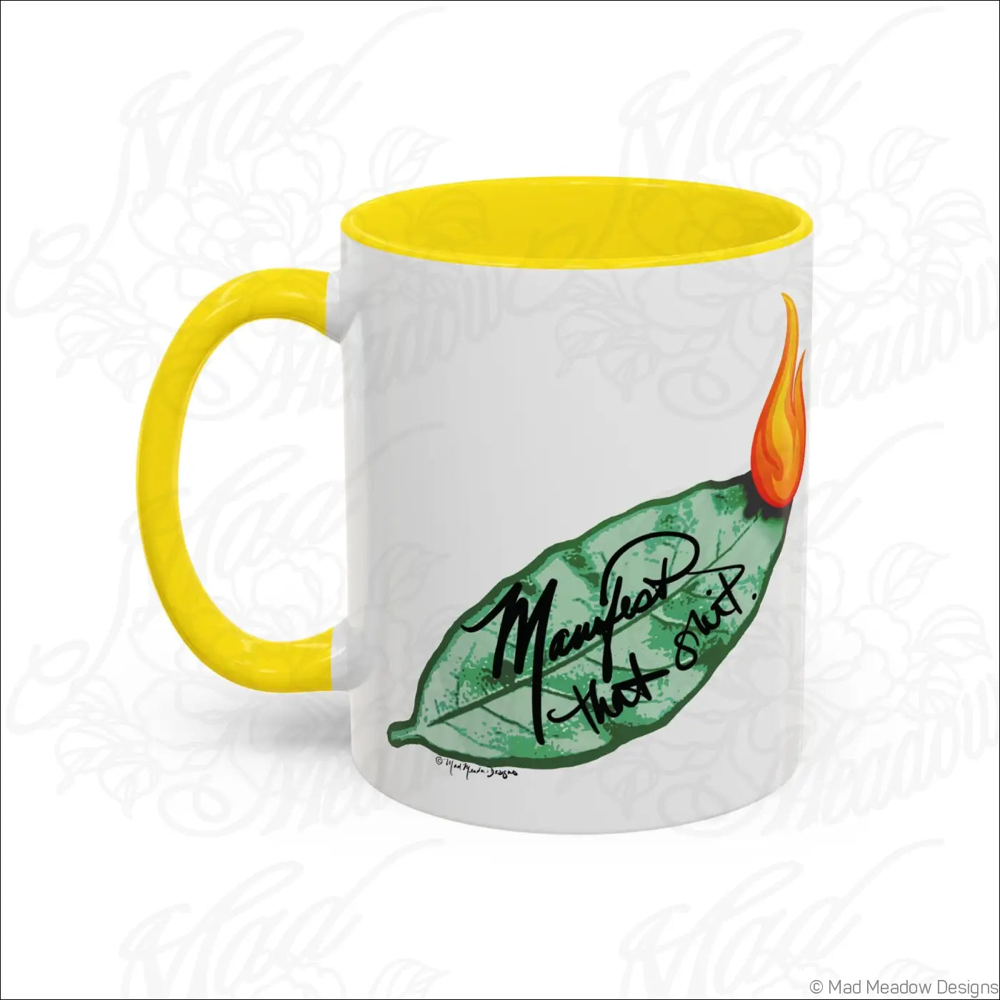 White ceramic mug with glossy finish bright yellow colored interior and bay leaf design saying manifest that stuff