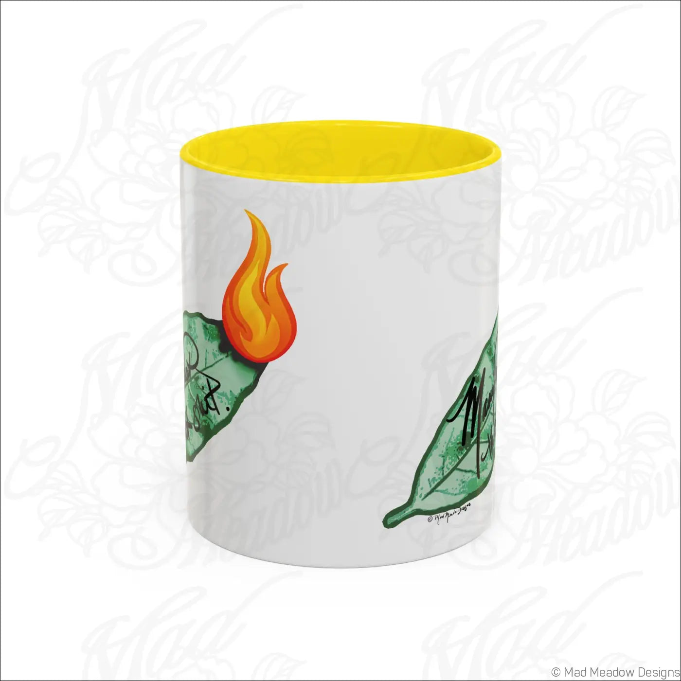 White ceramic mug with glossy finish, yellow colored interior, and a bay leaf with orange flames illustration