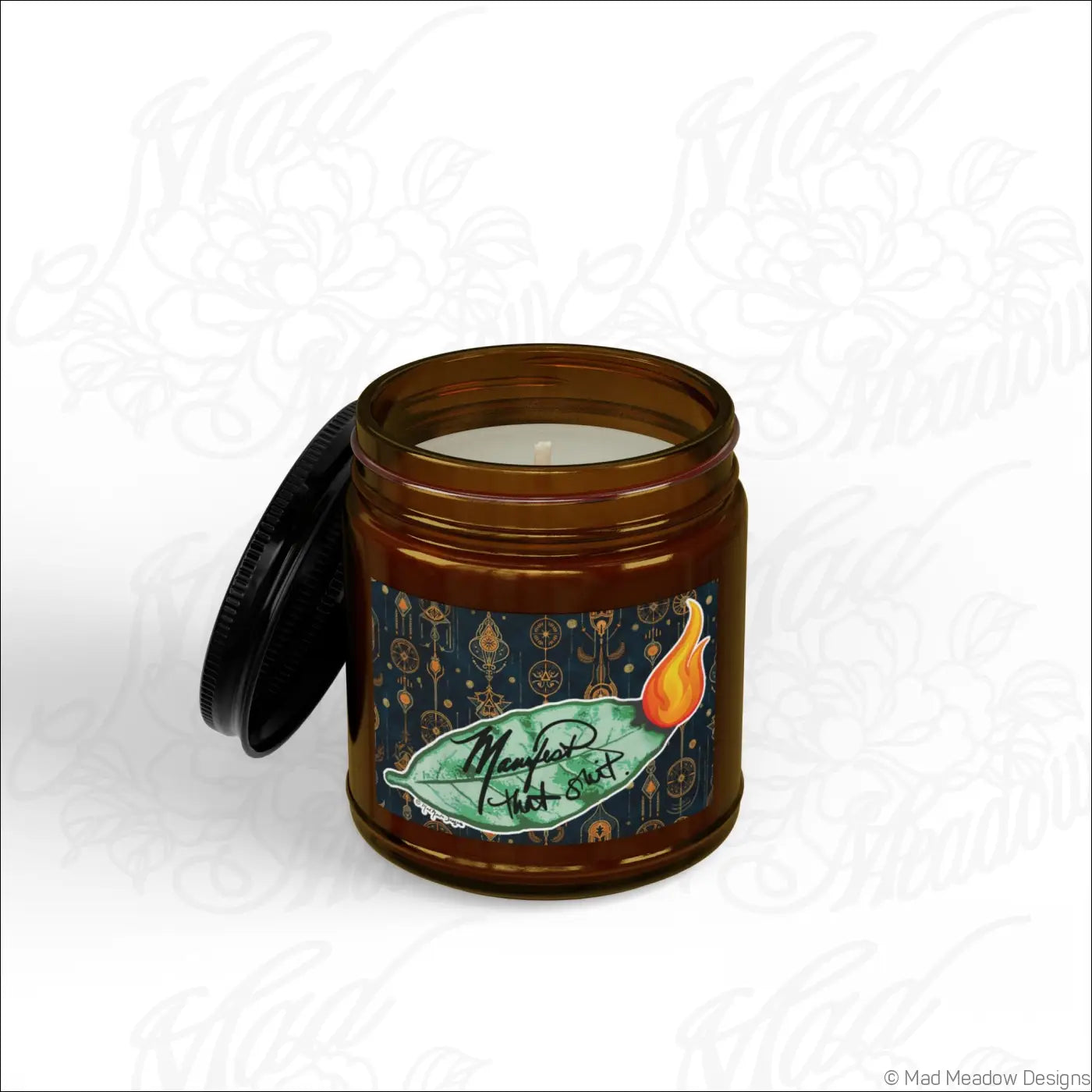 Brown glass jar soy wax candle with black lid and green leaf flame label manifest that sh!t bay leaf scent