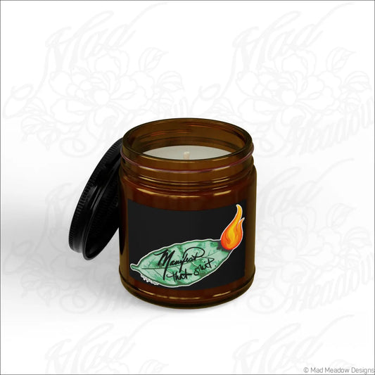 Manifest that shit burning bay leaf scented soy wax candle in a brown glass jar with a black lid and green leaf label
