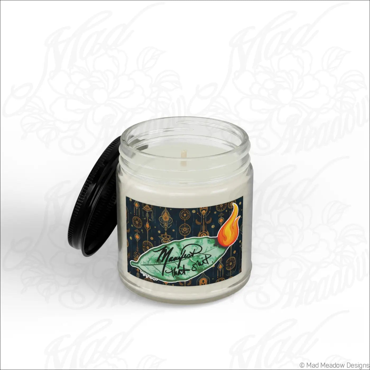 Manifest that sh!t burning bay leaf scented soy wax candle in a clear glass jar with black lid and green leaf label