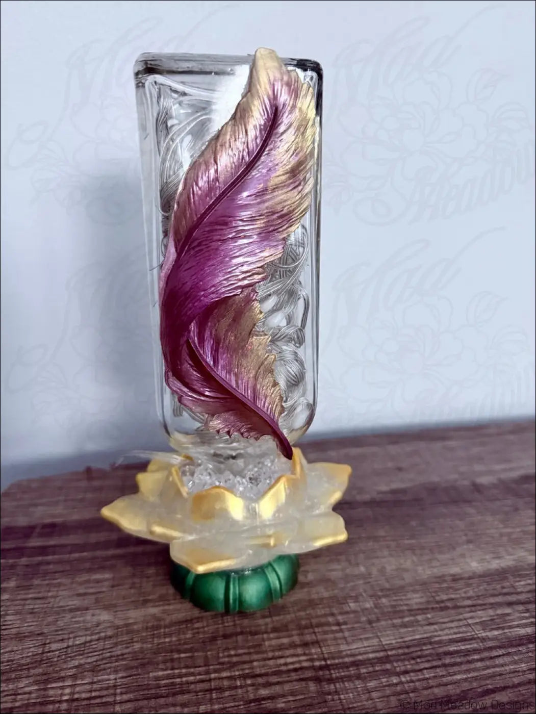 Translucent antique glass apothecary bottle usb light with maroon and gold feather on golden lotus base