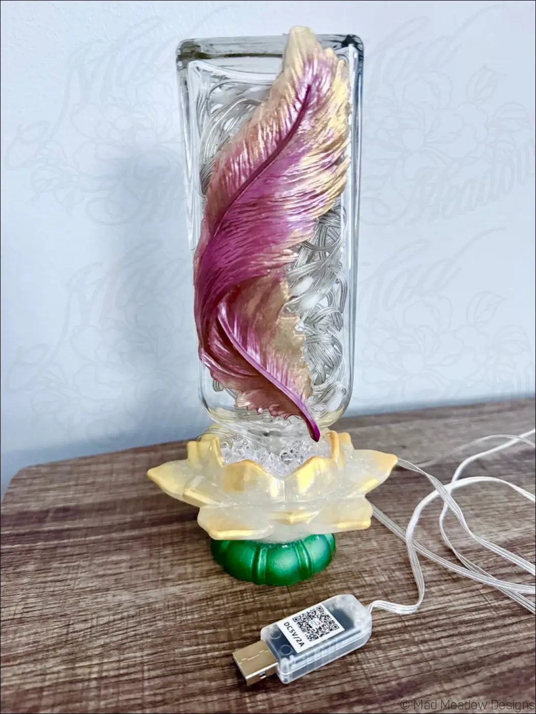 Translucent antique glass apothecary bottle usb light with maroon and gold feather design on golden lotus base