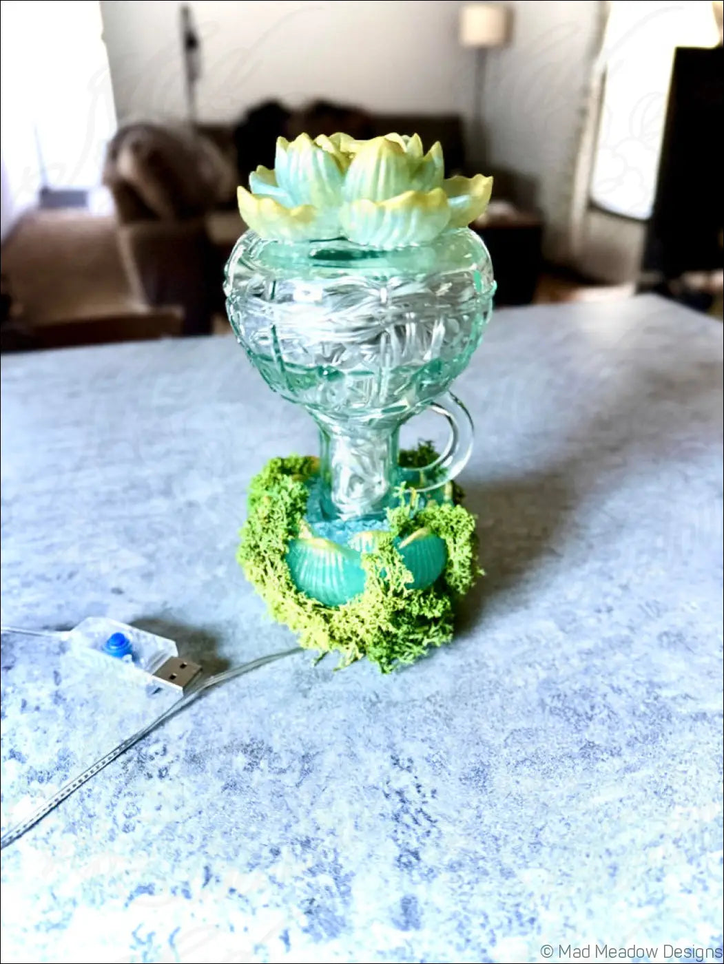 Mint green vintage glass humidifier with lotus flowers and moss accents topped with white lights usb lamp