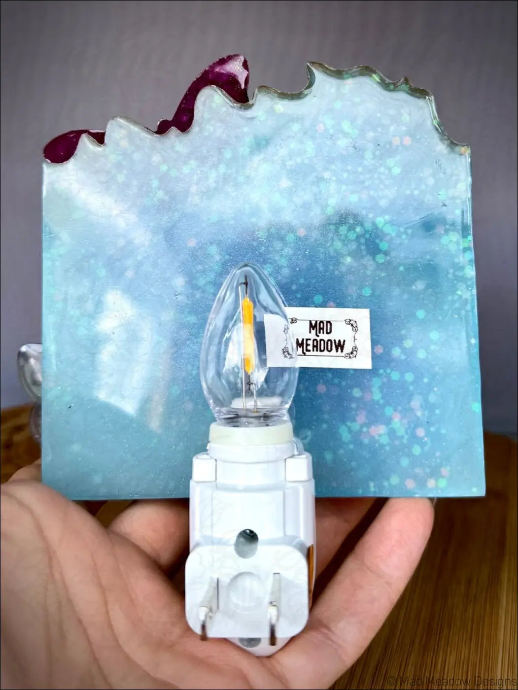 Mesmerizing crystal cluster night light with delicate iridescent moths in soft aqua blue resin on a plug-in base
