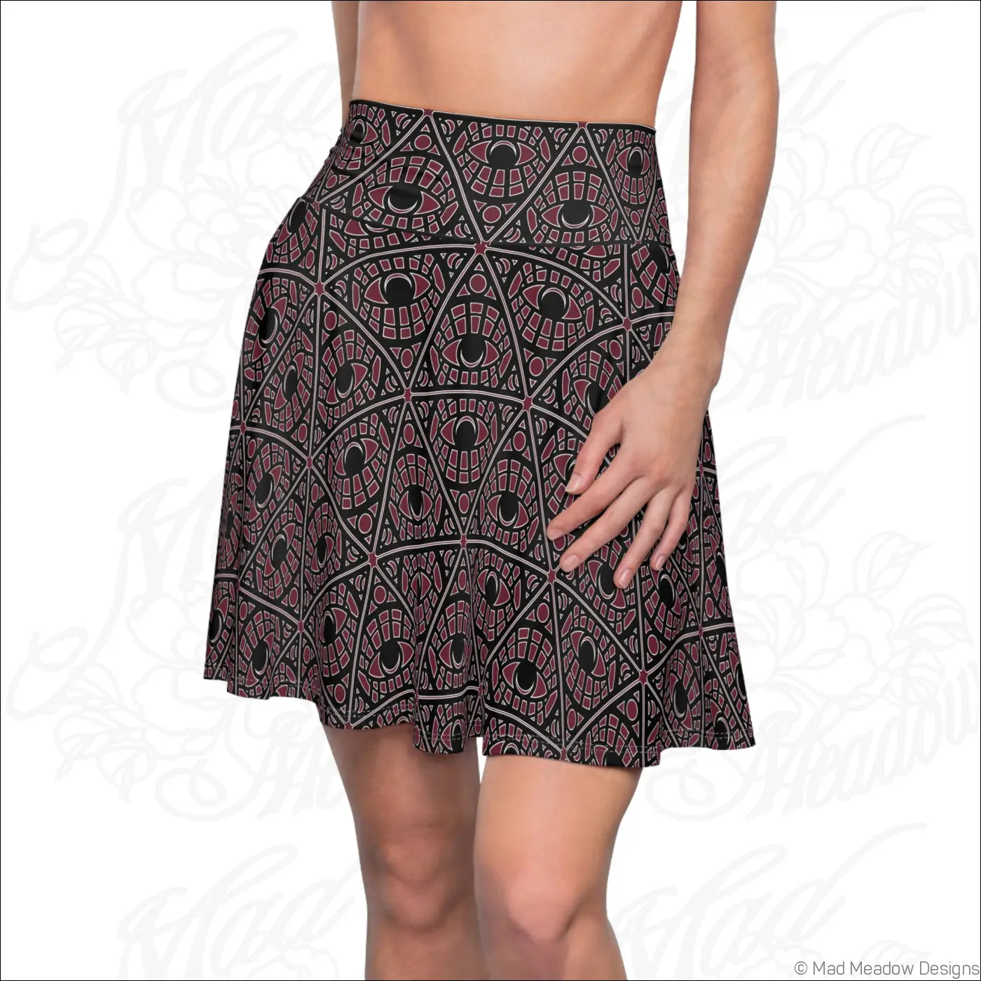 A bordeaux skater skirt with stretch fabric featuring a bold mystic eye tribal pattern and a printed care label