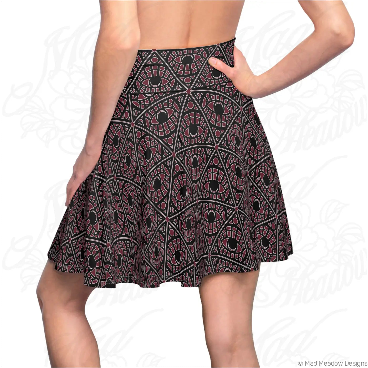 A bordeaux skater skirt in stretch fabric with a mystic eye tribal pattern and a printed care label visible
