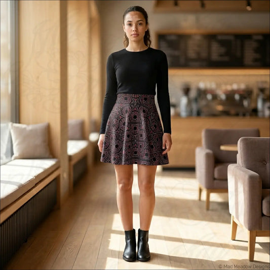 A black and purple mystic eye tribal pattern skater skirt in stretch fabric paired with a long-sleeved top