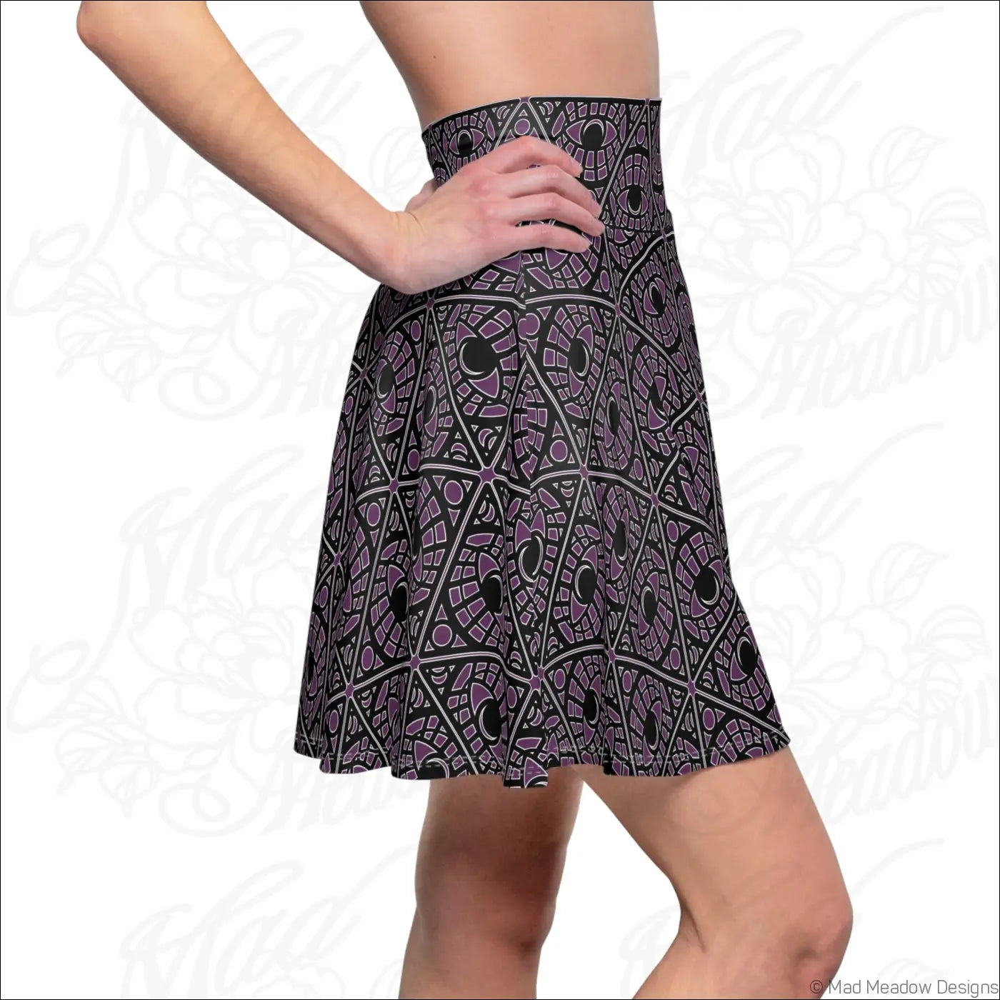 A black and purple high waisted skater skirt with eye motif geometric print and stretch fabric featuring printed care label