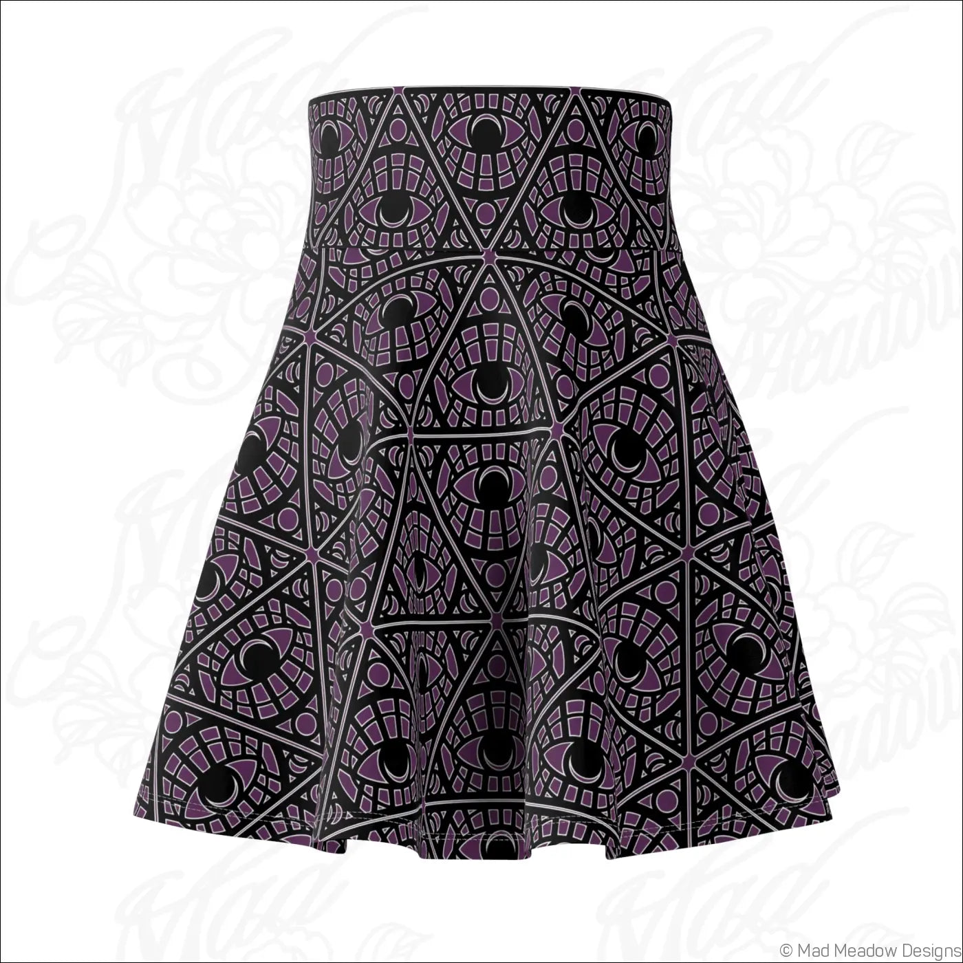 A flared eggplant skater skirt with bold mystic eye tribal pattern in stretch fabric featuring a printed care label