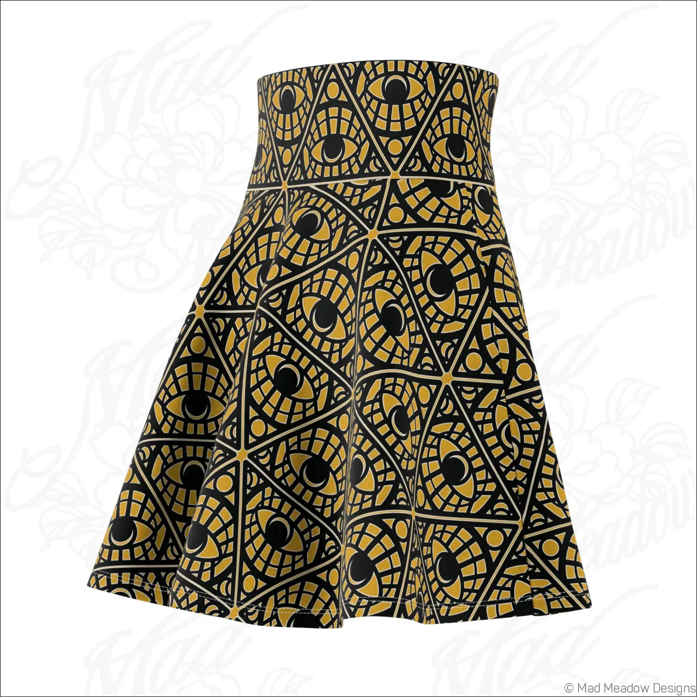 A mustard skater skirt with a bold geometric mystic eye tribal pattern in gold and black stretch fabric with printed care label