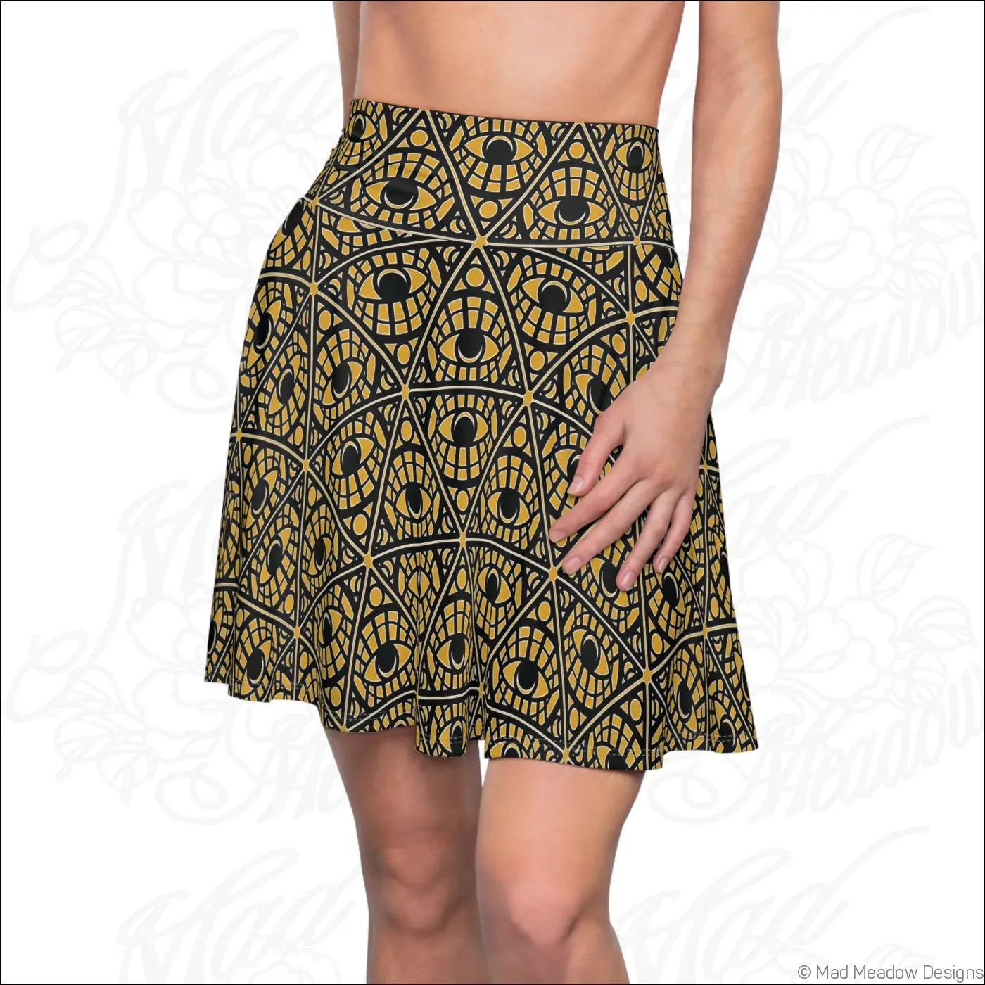 High waisted mustard skater skirt with bold gold and black mystic eye tribal pattern on stretch fabric with printed care label