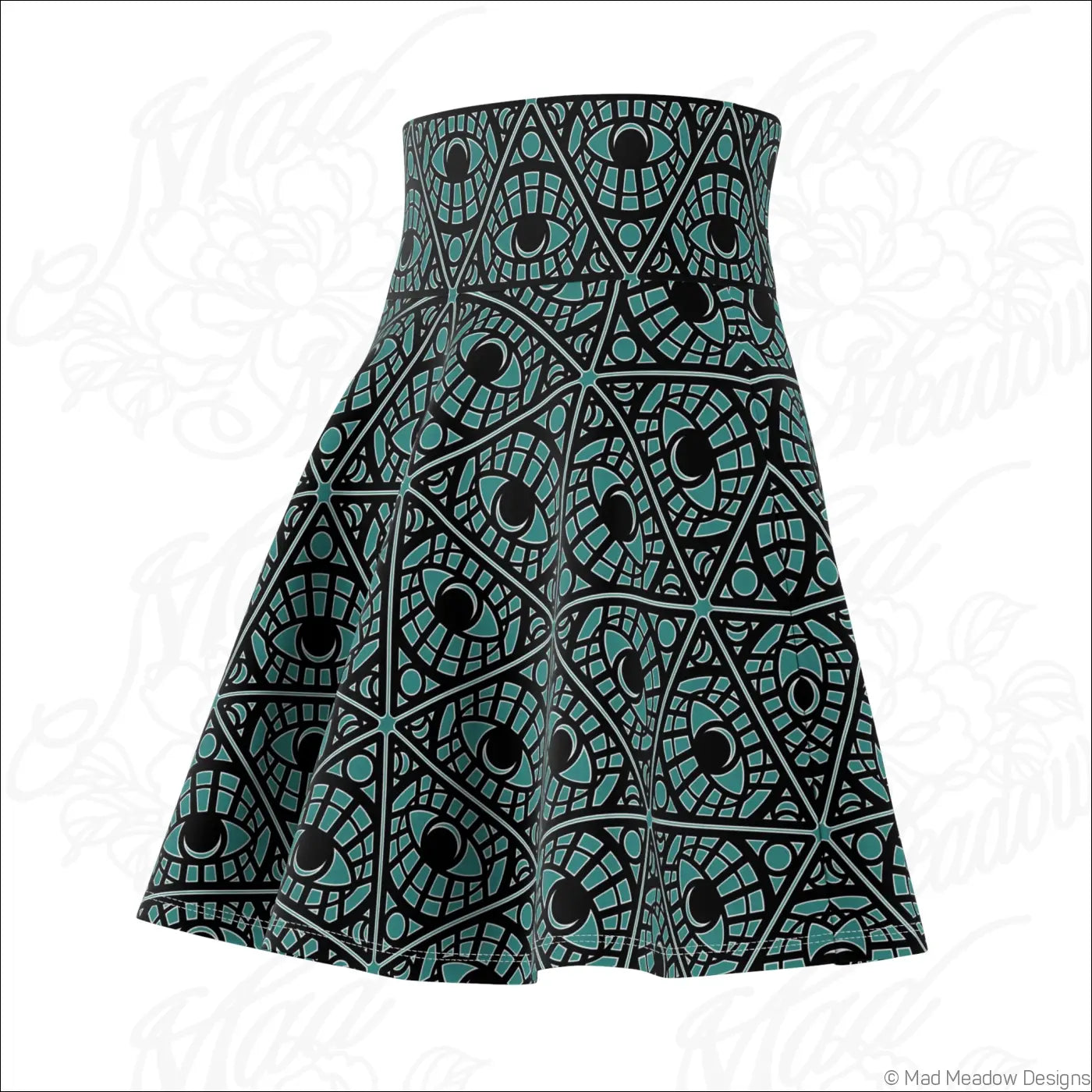 A teal skater skirt with a bold geometric eye print made from stretch fabric with a printed care label visible