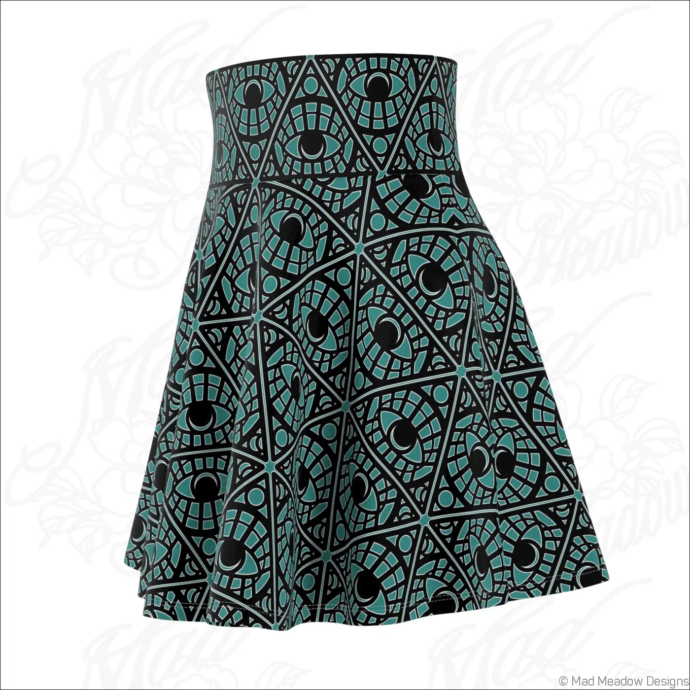 A teal skater skirt with a bold mystic eye tribal pattern made of stretch fabric featuring a printed care label