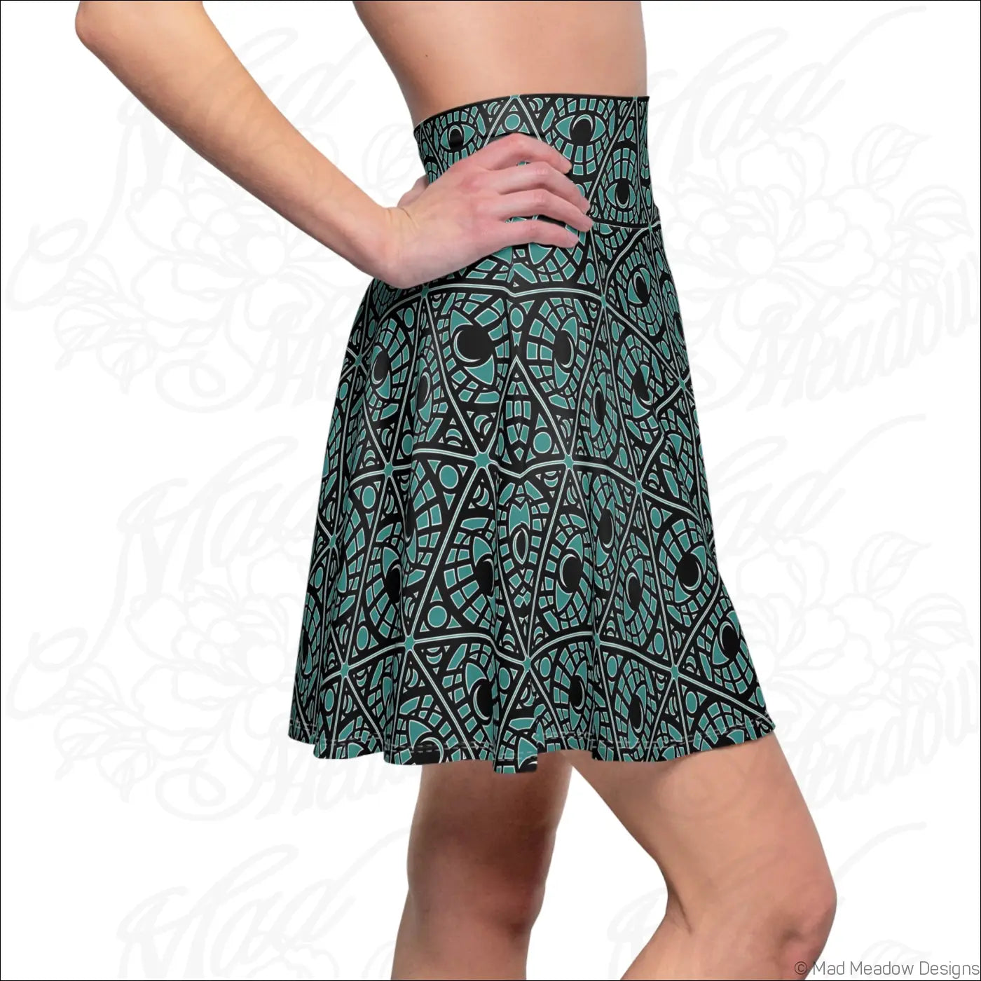 Teal and black geometric flared skater skirt with high waistband made of stretch fabric and printed care label visible