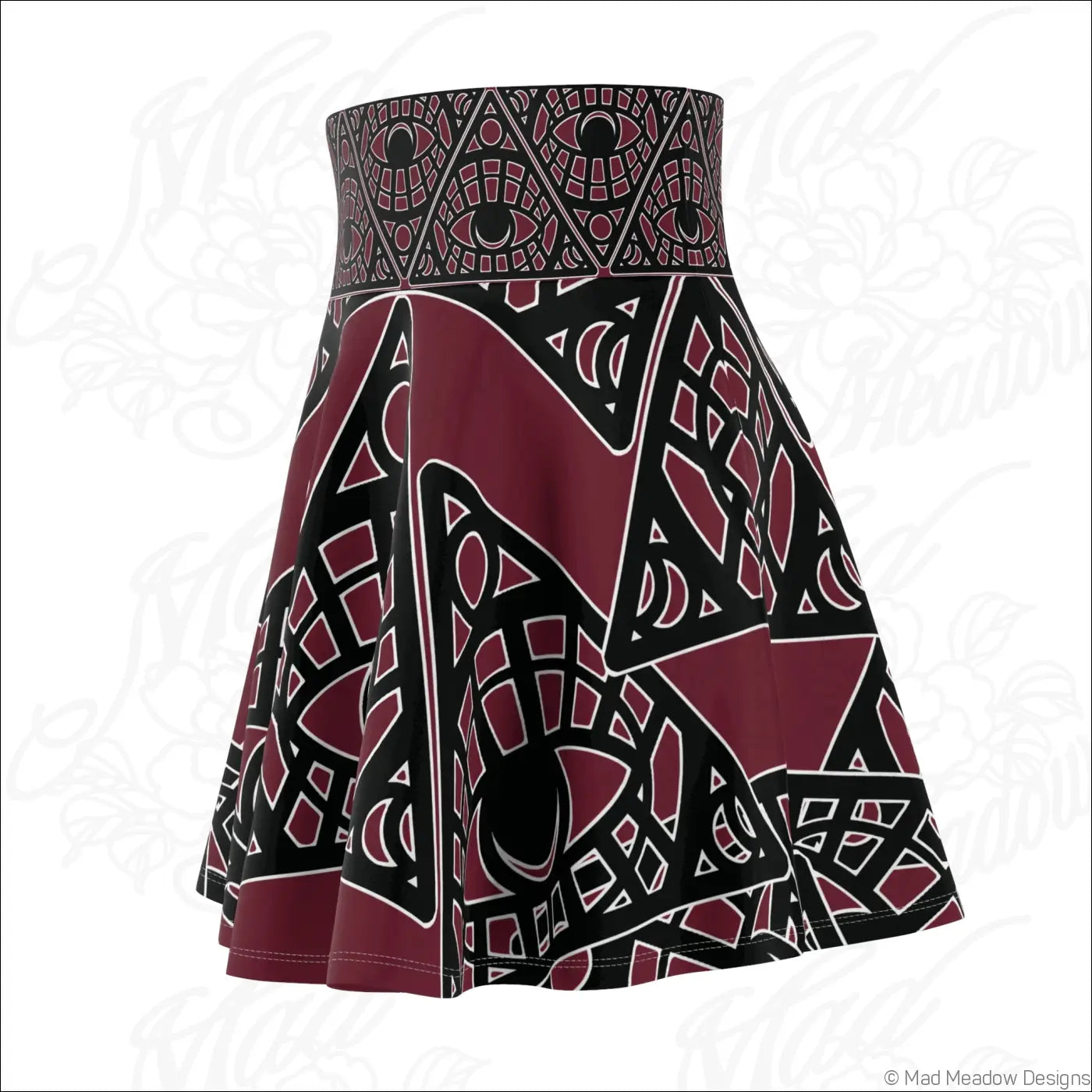A stretch fabric skater skirt with a bold maroon and black mystic eye geometric print and printed care label