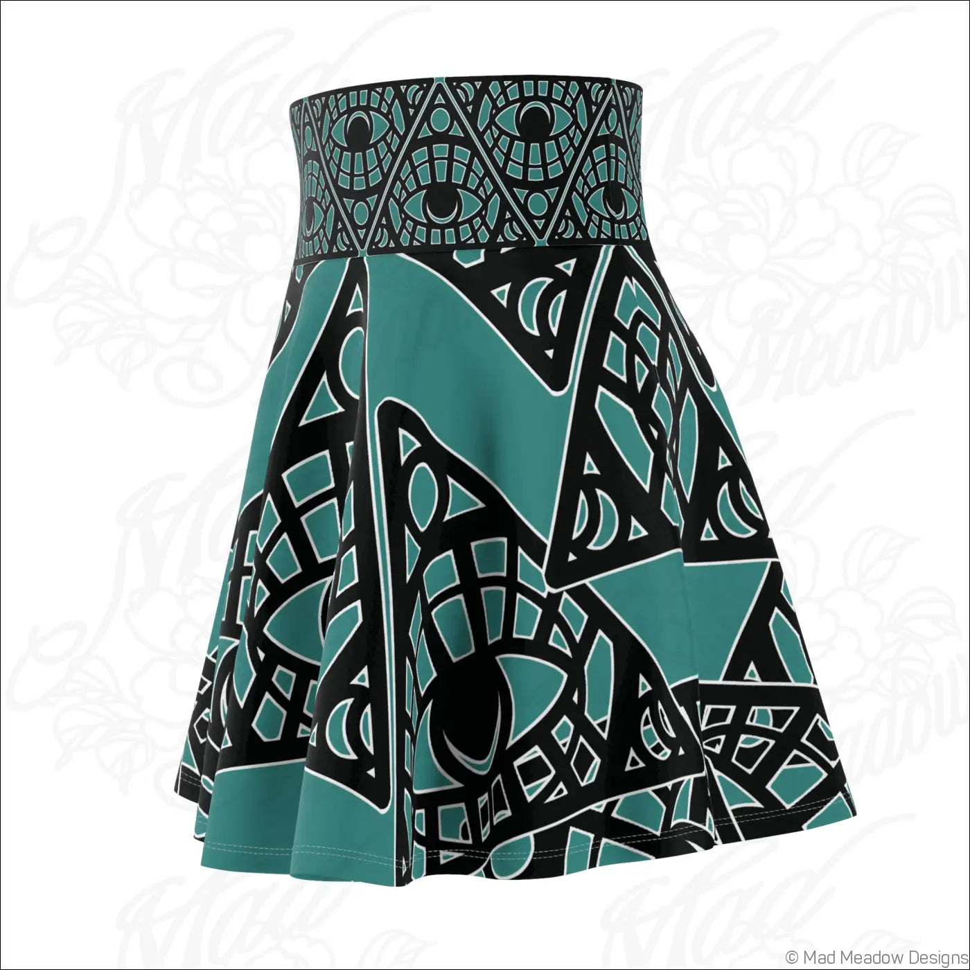 A teal and black tribal skater skirt with mystic eye print and stylized eye motifs featuring a printed care label