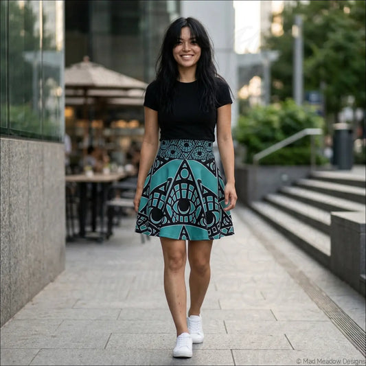 Teal and black tribal skater skirt with bold mystic eye print and geometric pattern featuring printed care label