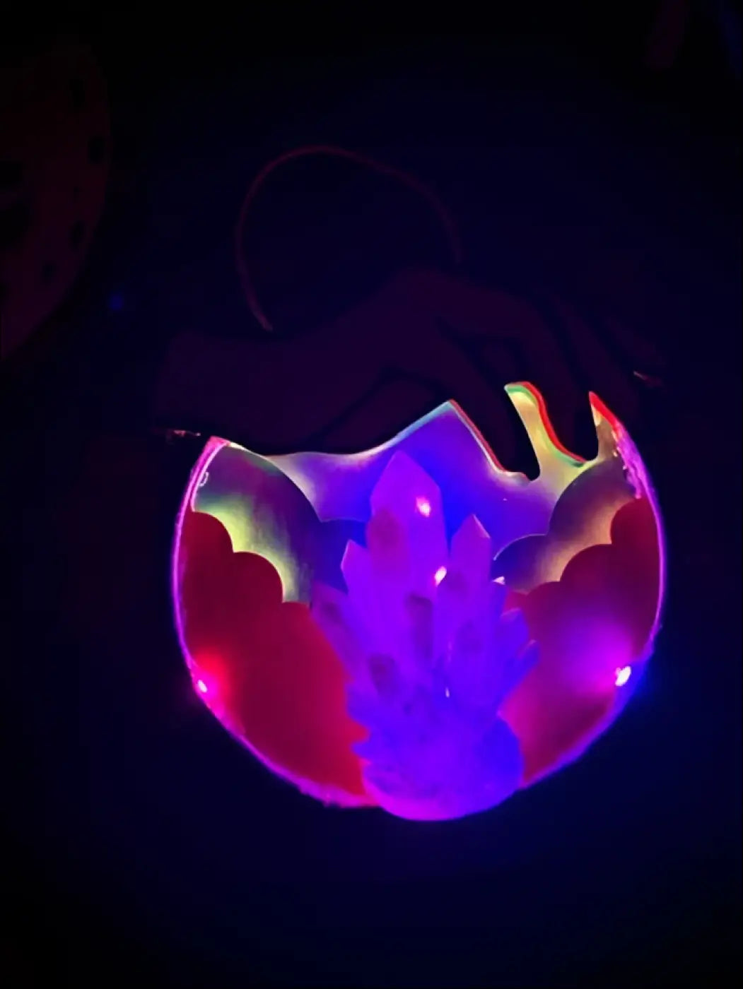 A glowing purple and pink cracked egg led hanging crystal ball with internal crystals and usb color control light