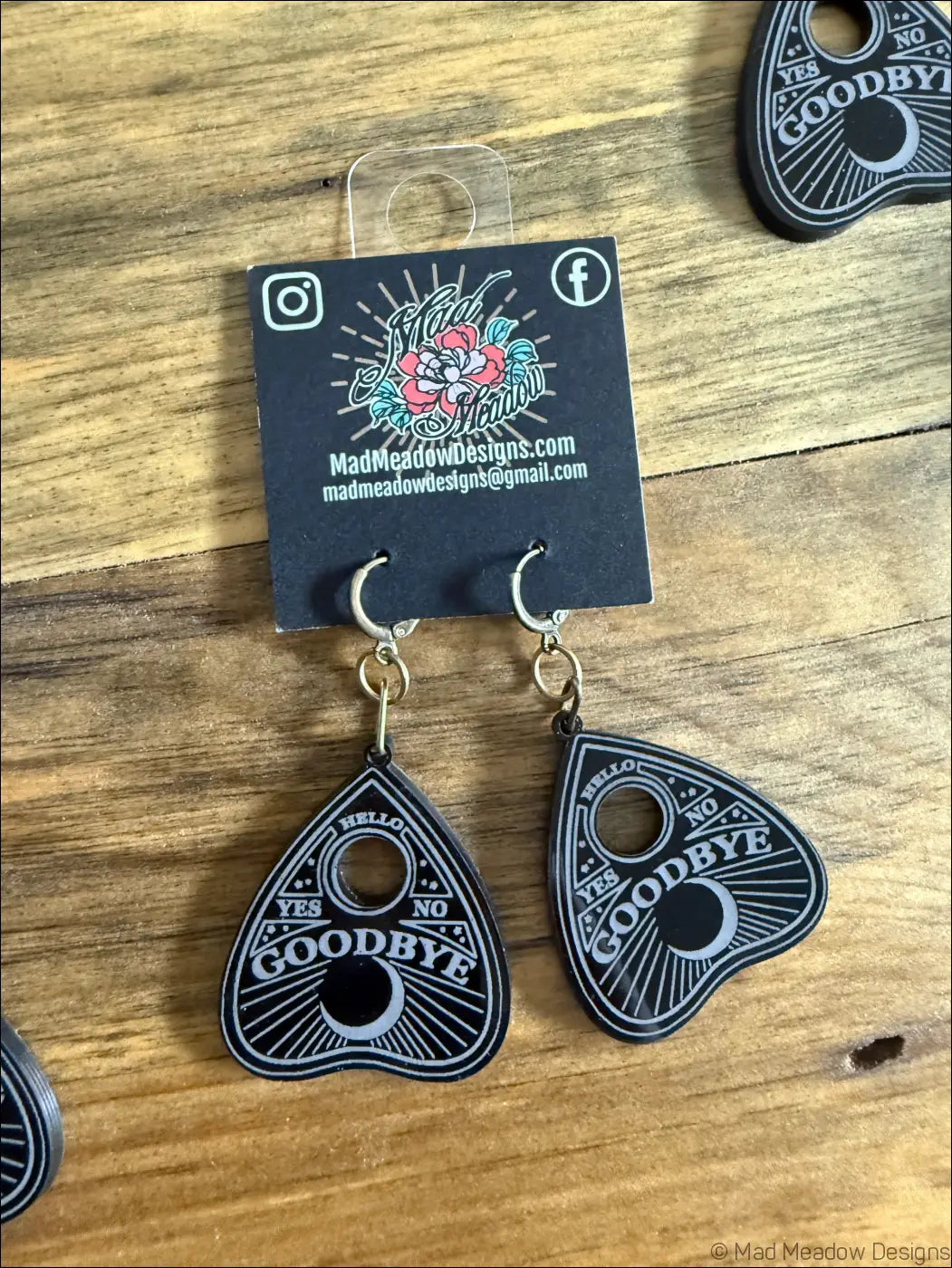 Black ouija planchette laser cut plexiglass earrings with white lettering and silver toned metal hooks