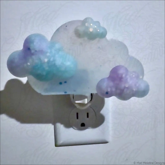Pastel blue and purple clouds wall night light with glittery details by mad meadow designs on plug-in base