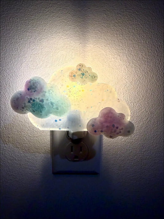 Pastel blue and purple clouds wall night light with glittery specks and soft glow by mad meadow designs on plug-in base