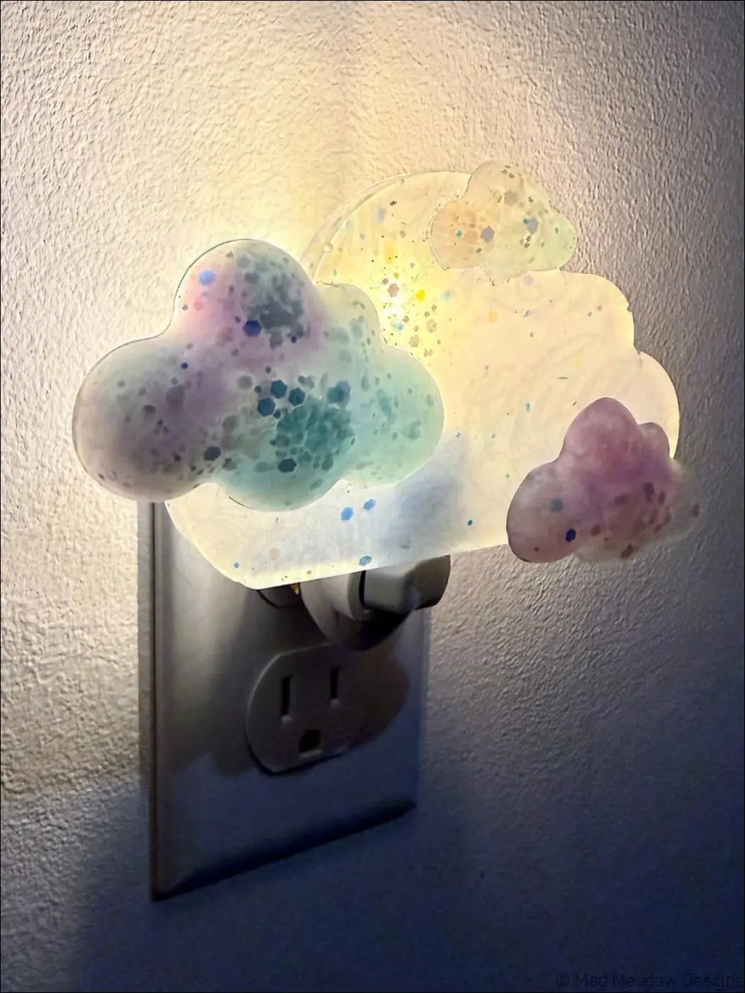 Pastel blue and purple clouds wall night light with speckled resin design on plug-in base by mad meadow designs