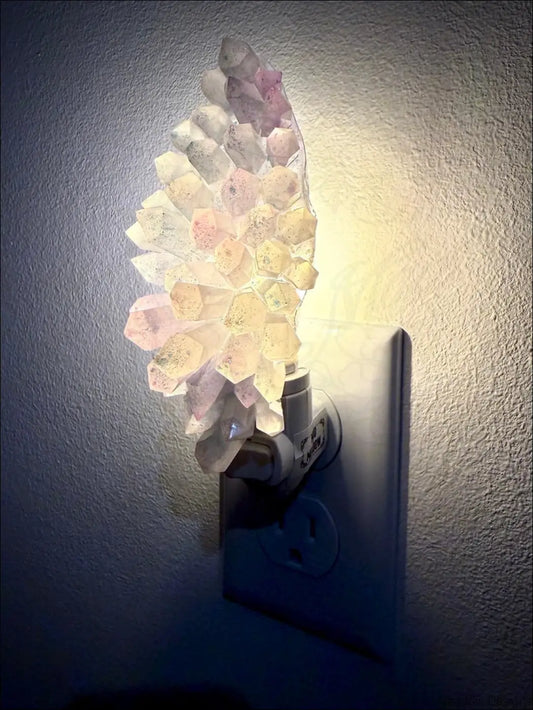 Pastel translucent white and purple crystal cluster resin wall night light with soft glow on plug-in base perfect for feather wall night decor