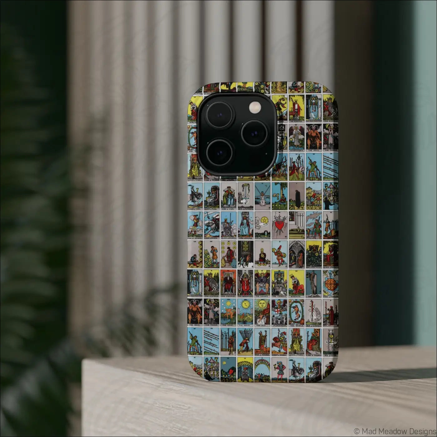 Back of a phone case with rigid polycarbonate shell featuring vibrant vintage tarot card collage design