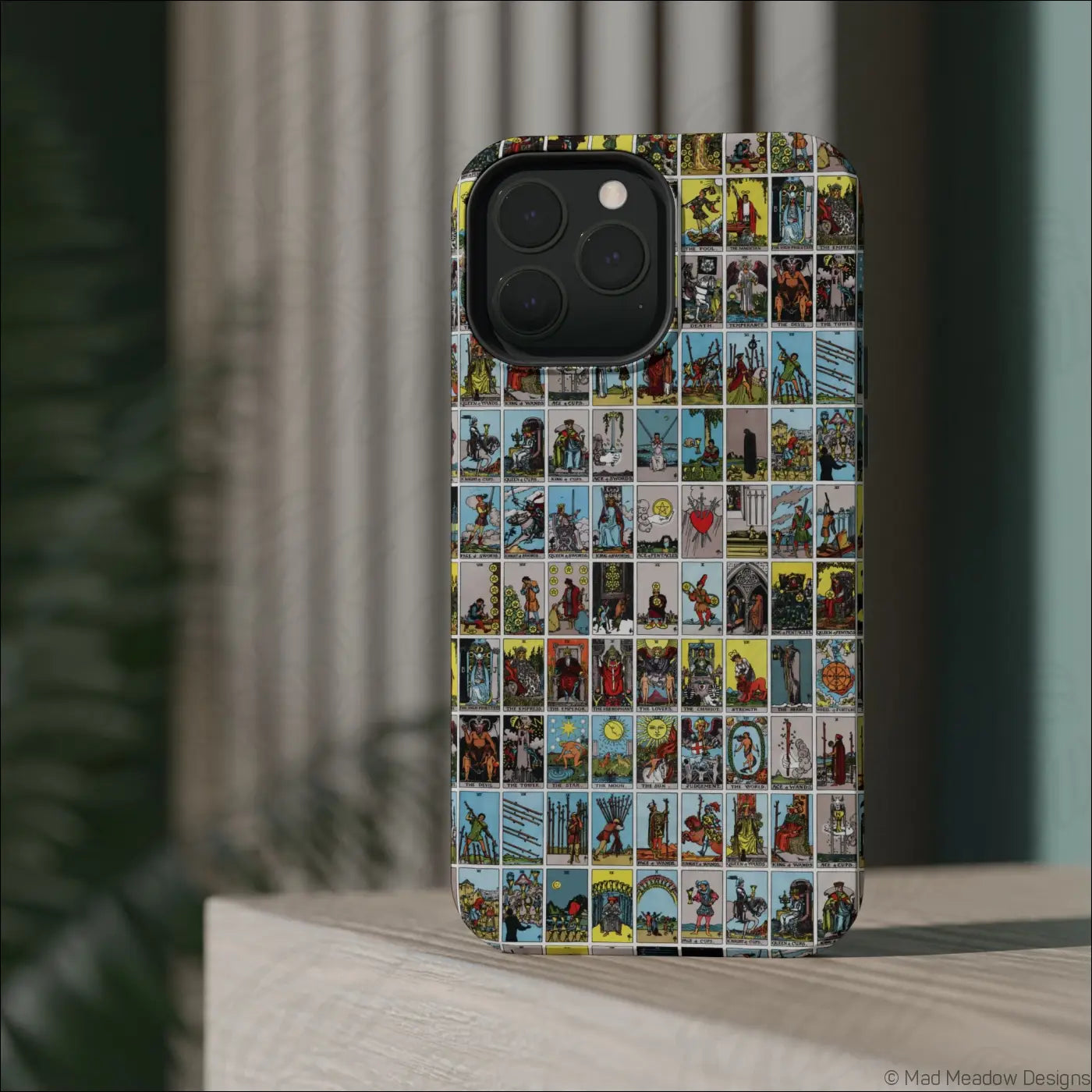 Back of a phone case with a colorful vintage tarot card collage on a rigid polycarbonate shell for impact resistance