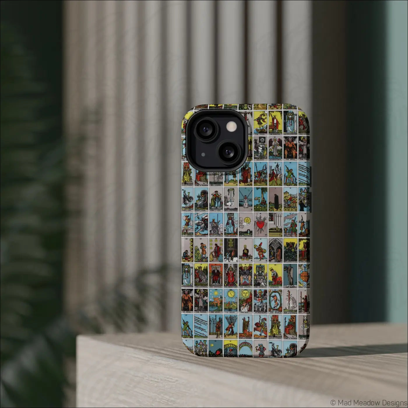 Back of a vibrant phone case with vintage tarot card collage in rich colors made of rigid polycarbonate shell