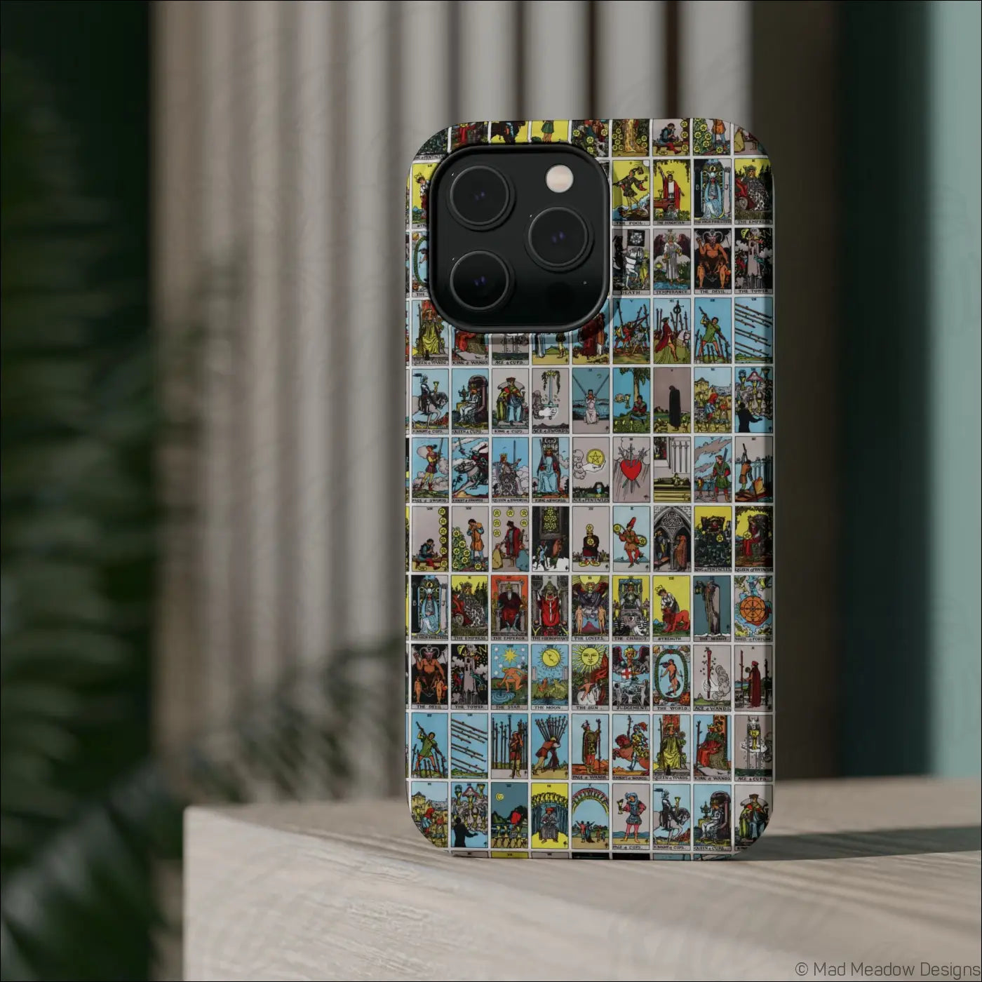 Back of a phone case with a vibrant vintage tarot card collage pattern on a rigid polycarbonate shell for impact resistance