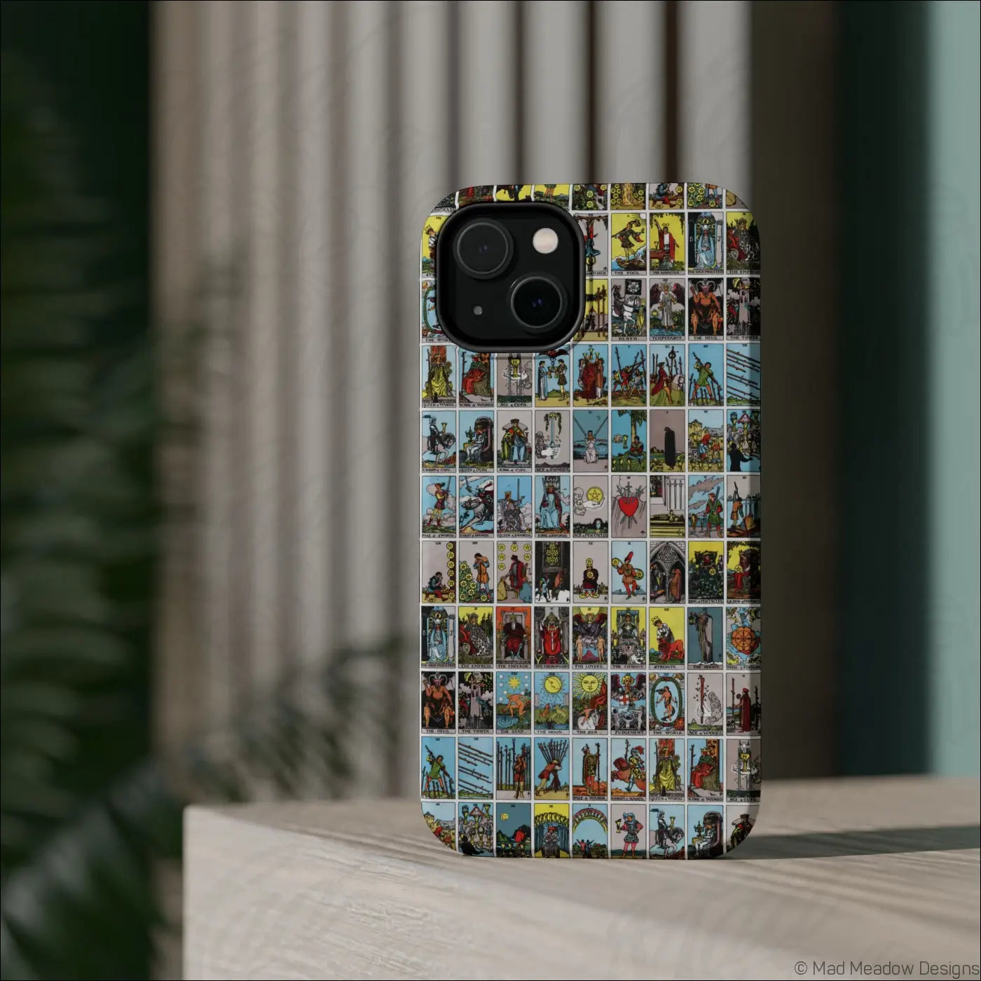 Back of a phone case with a colorful vintage tarot card collage design on a rigid polycarbonate shell for impact resistance