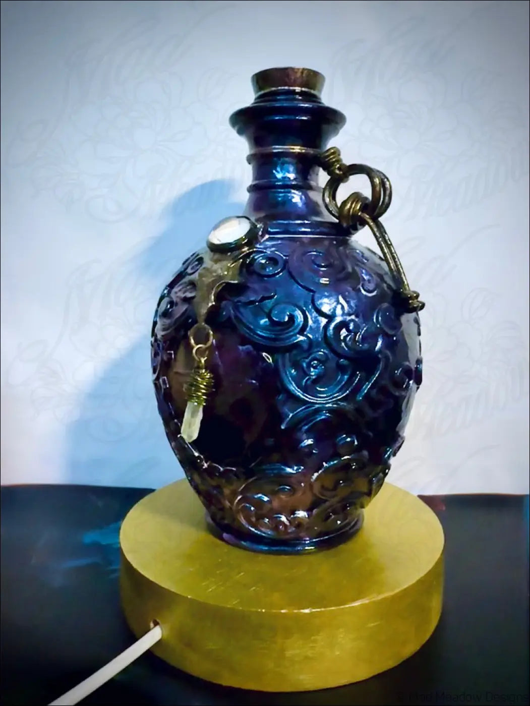 Deep blue glass potion bottle light with intricate carvings metallic handle cork stopper and crystal dangles