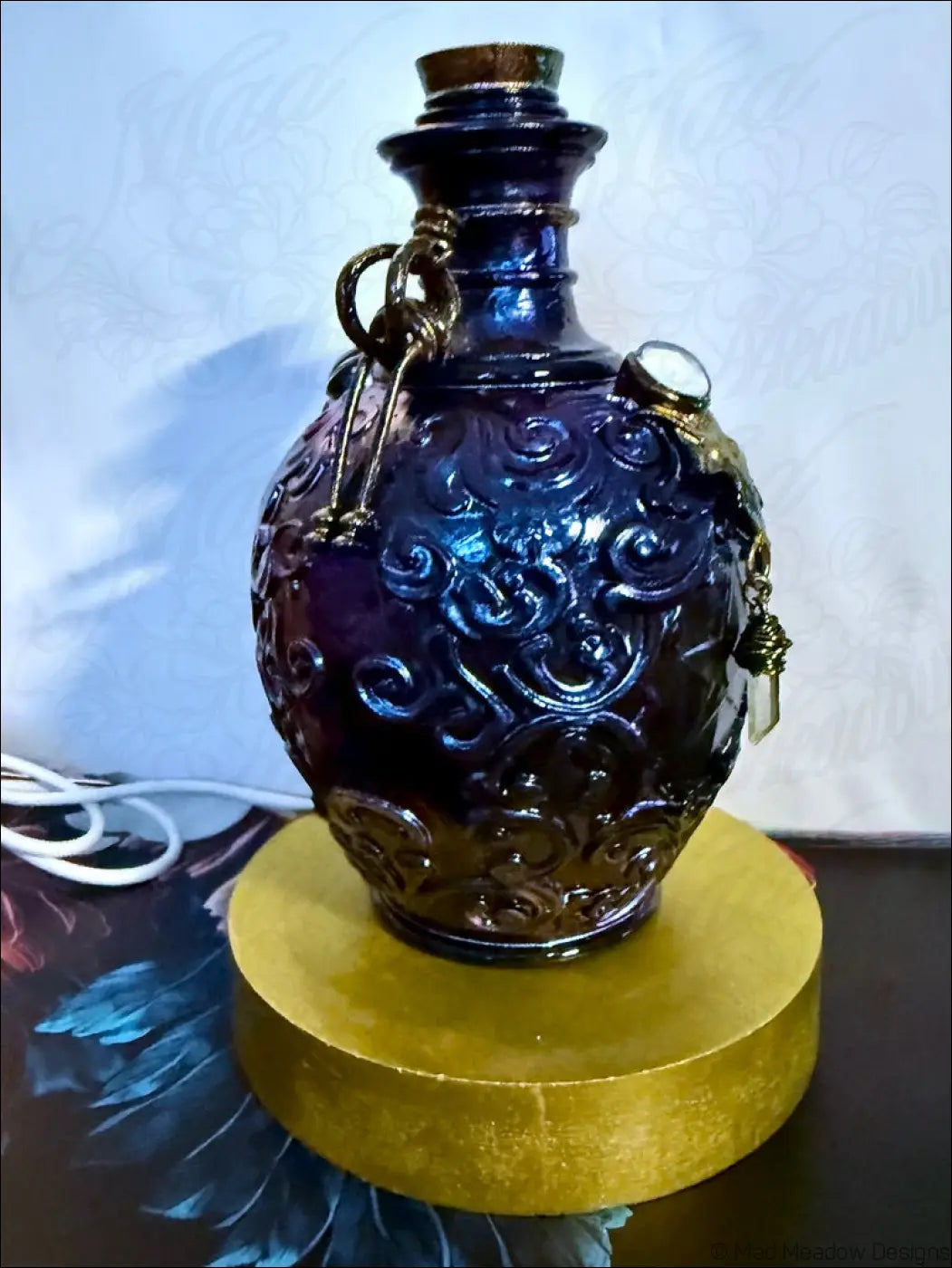 Deep blue intricately carved glass potion bottle light with metallic accents cork stopper and crystal dangles