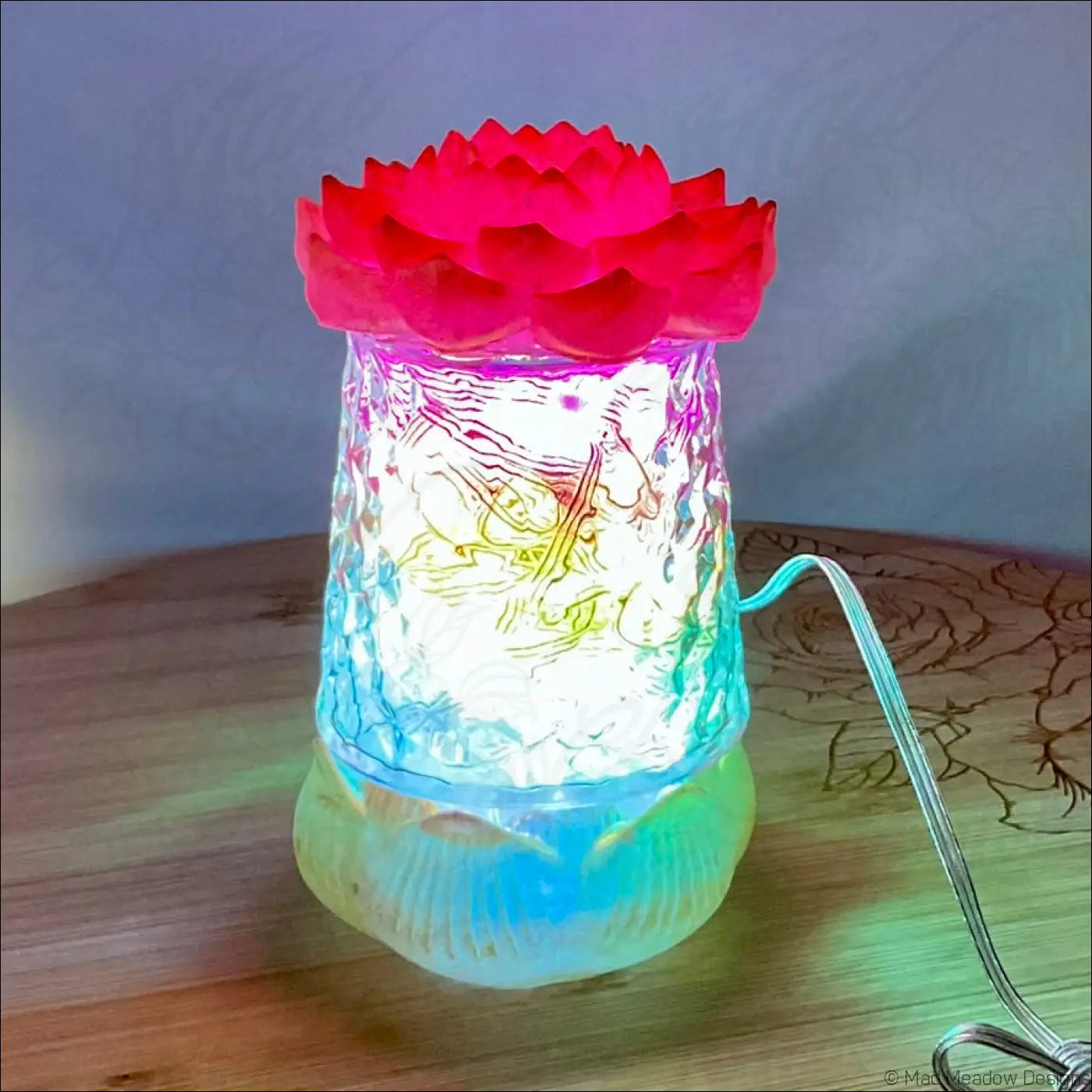 A glowing translucent glass lamp with a vibrant red lotus flower and gold designs in the red pink gold resin usb light
