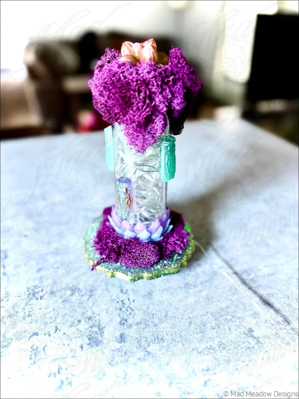 A vibrant purple floral resin cicadas arrangement on a vintage glass cylinder with white usb light and turquoise accents
